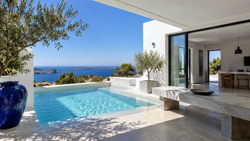 White villa with a swimming pool and a sea view