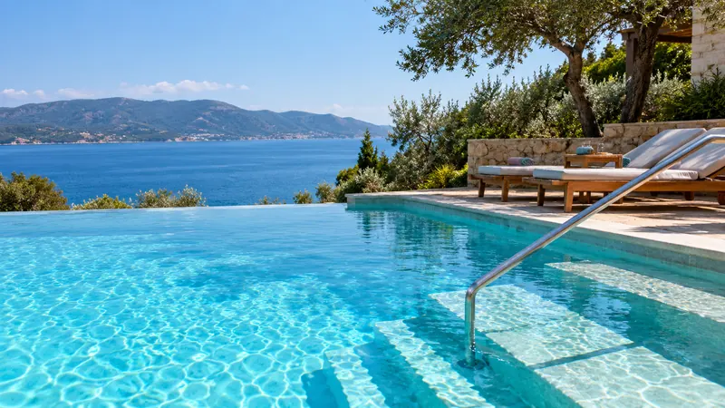 Pool steps beside vivid blue water